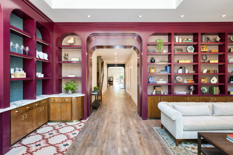 a living room filled with furniture and lots of shelves