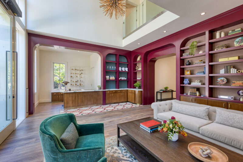 a living room filled with furniture and a book shelf