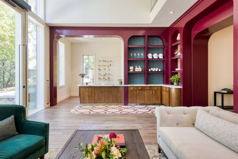 a living room filled with furniture and lots of windows