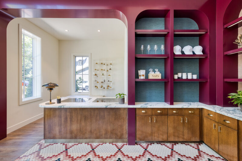 a kitchen area with a sink, cabinets, and a window