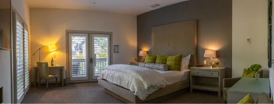 a bedroom with a large bed and a sliding glass door