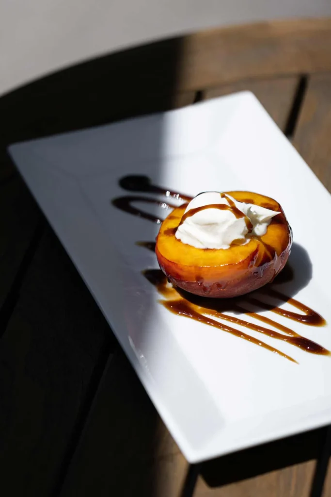 a white plate topped with a dessert covered in cream