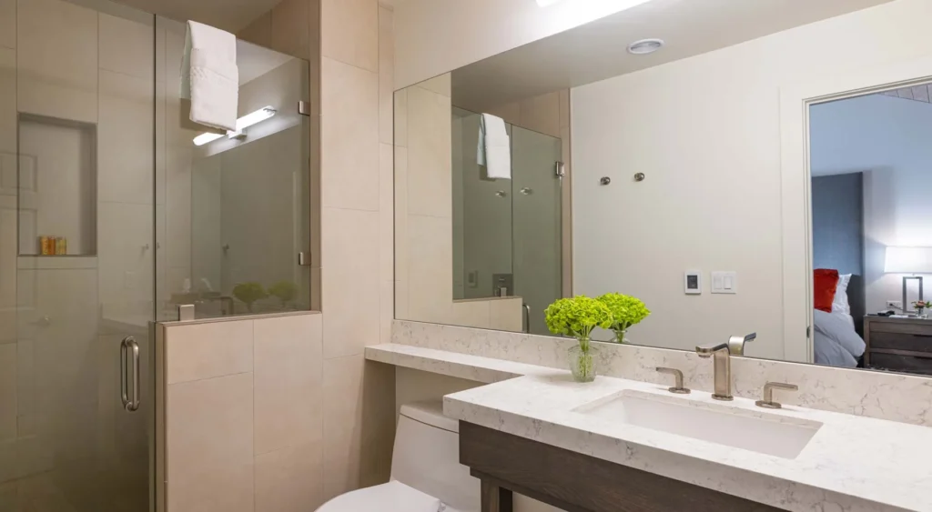 a bathroom with a sink, toilet, and shower