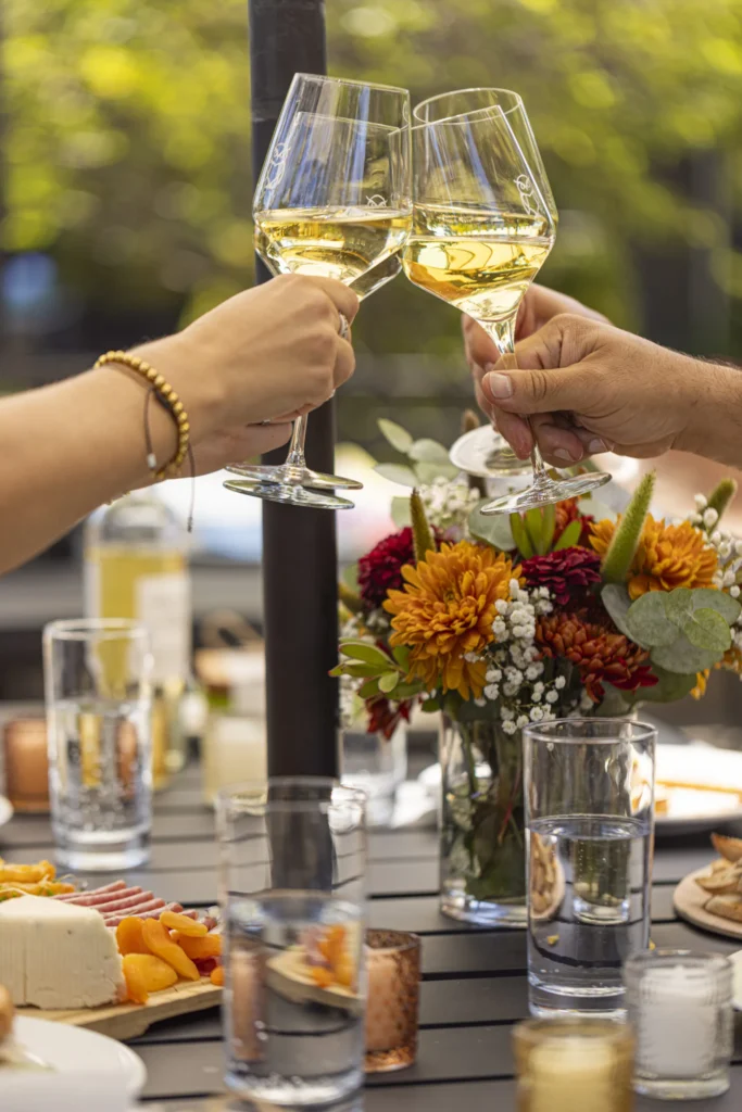 a couple of people that are holding wine glasses