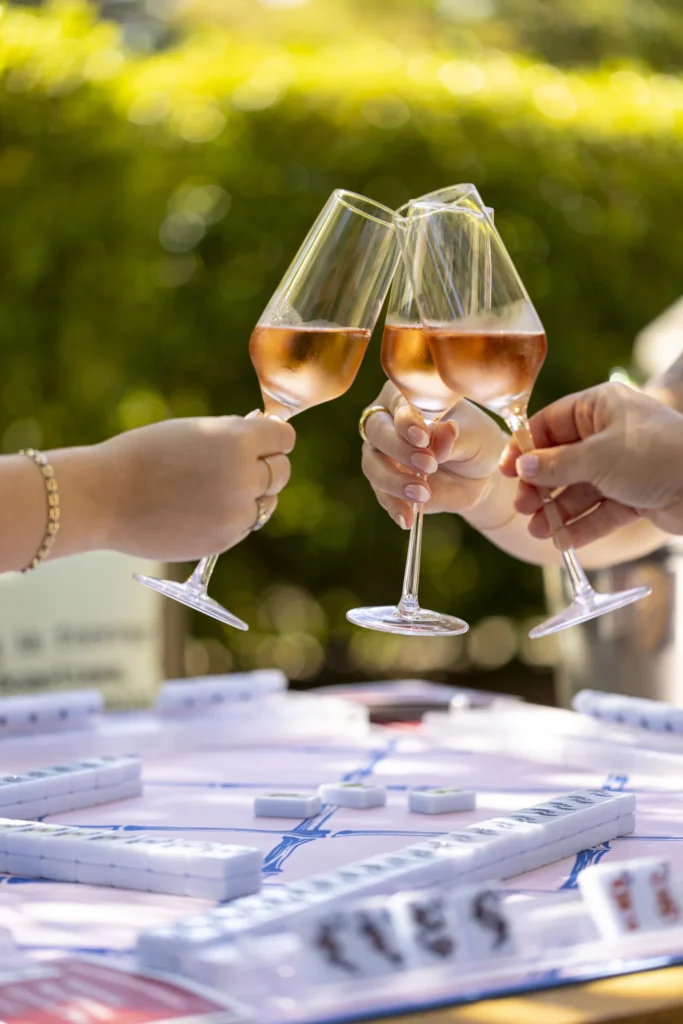 a group of people holding glasses of wine