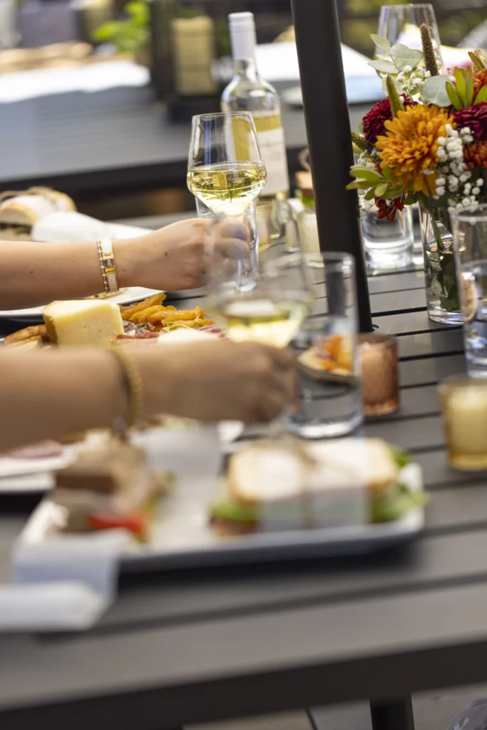a group of people sitting at a table with plates of food