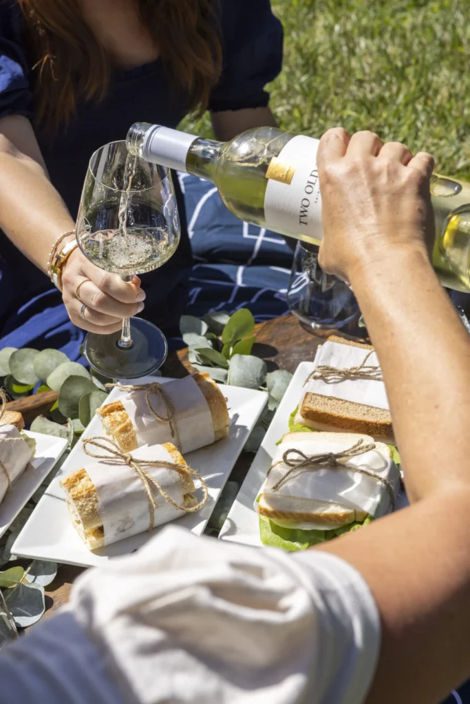 a couple of people that are pouring some wine