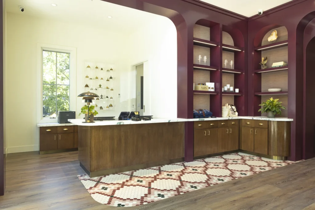 a large kitchen with a wooden floor and purple walls