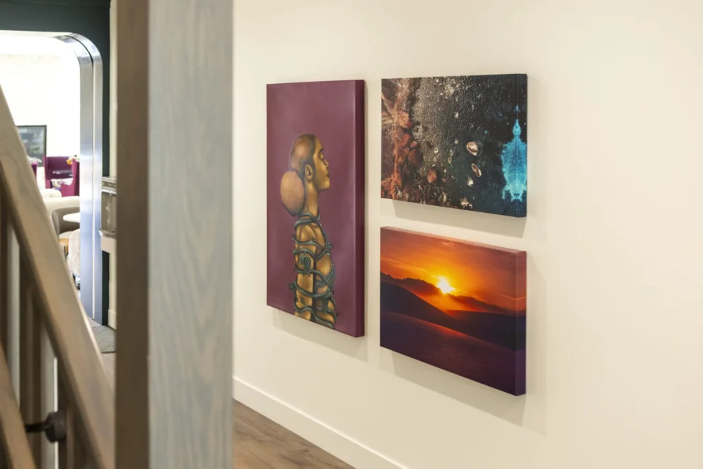 a hallway with three paintings hanging on the wall