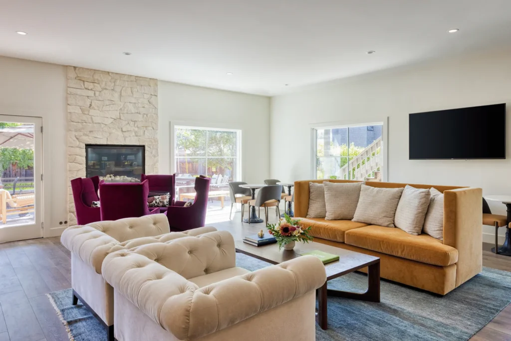 a living room filled with furniture and a flat screen tv