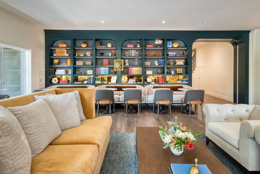 a living room filled with furniture and a book shelf