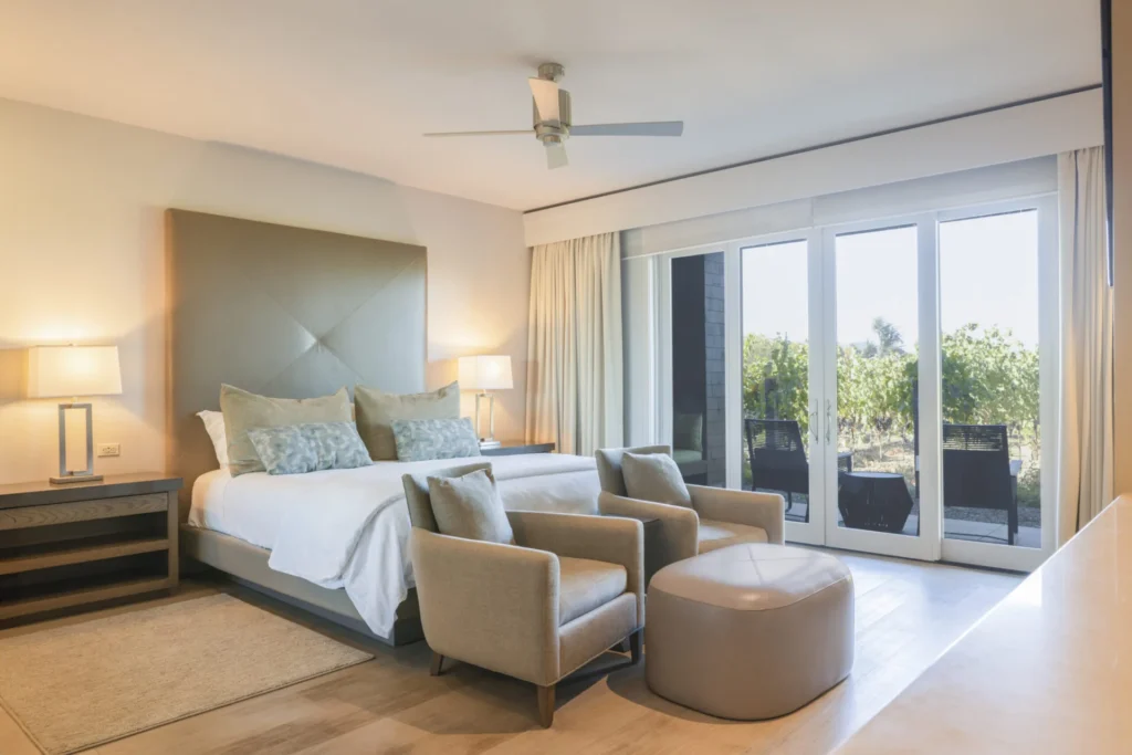 a bedroom with a large bed and a sliding glass door