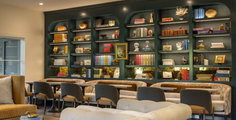 a room filled with lots of furniture and bookshelves