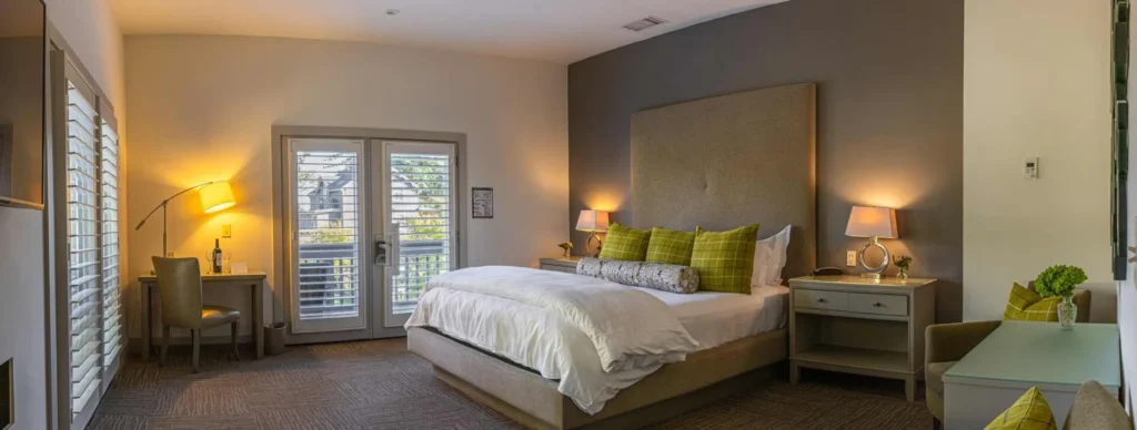 a bedroom with a large bed and two lamps