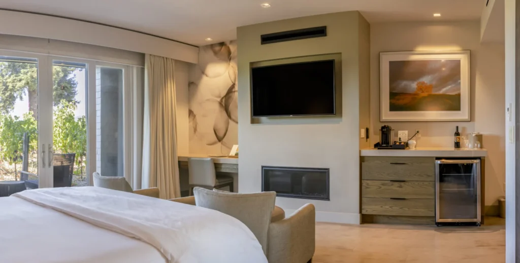 a bedroom with a large bed and a flat screen tv