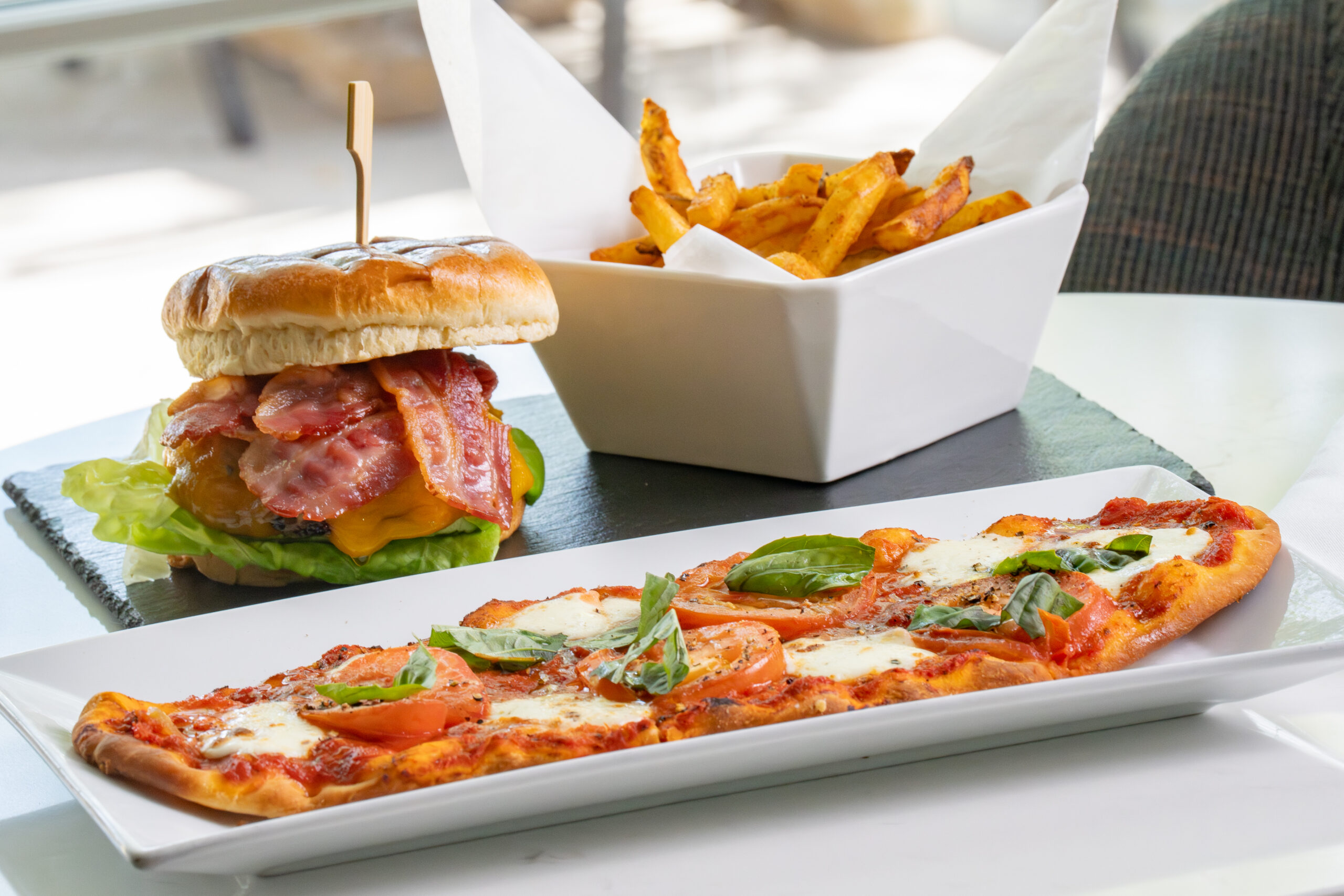 Grilled turkey BLT sandwich with bacon, lettuce, and tomato served with chips at The Study restaurant at SENZA Hotel.