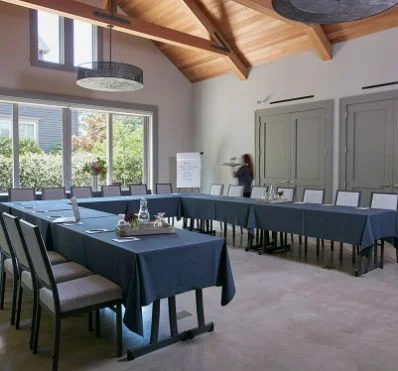 Conference room with U-shaped tables and presenter