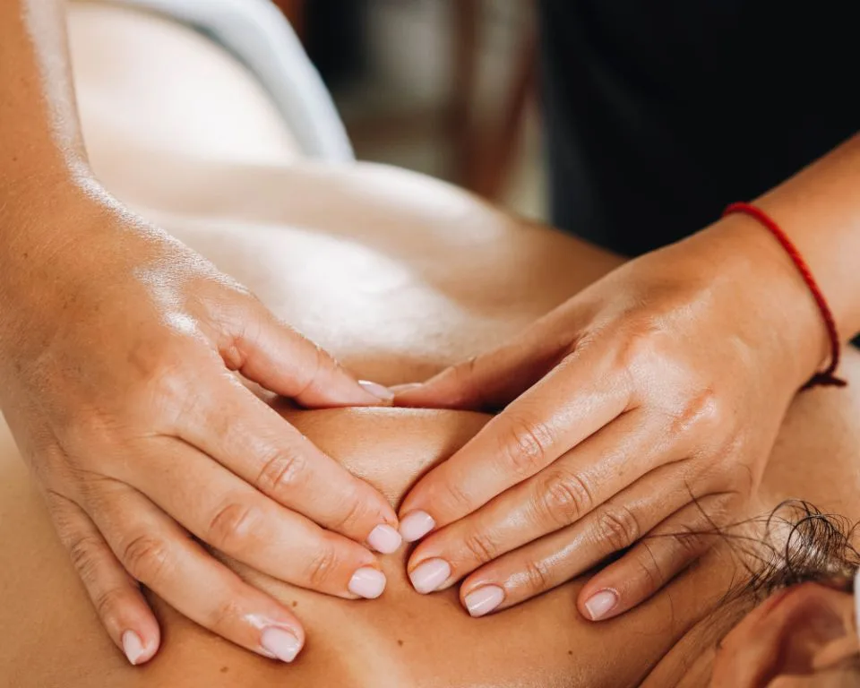 a woman getting a back massage at a spa