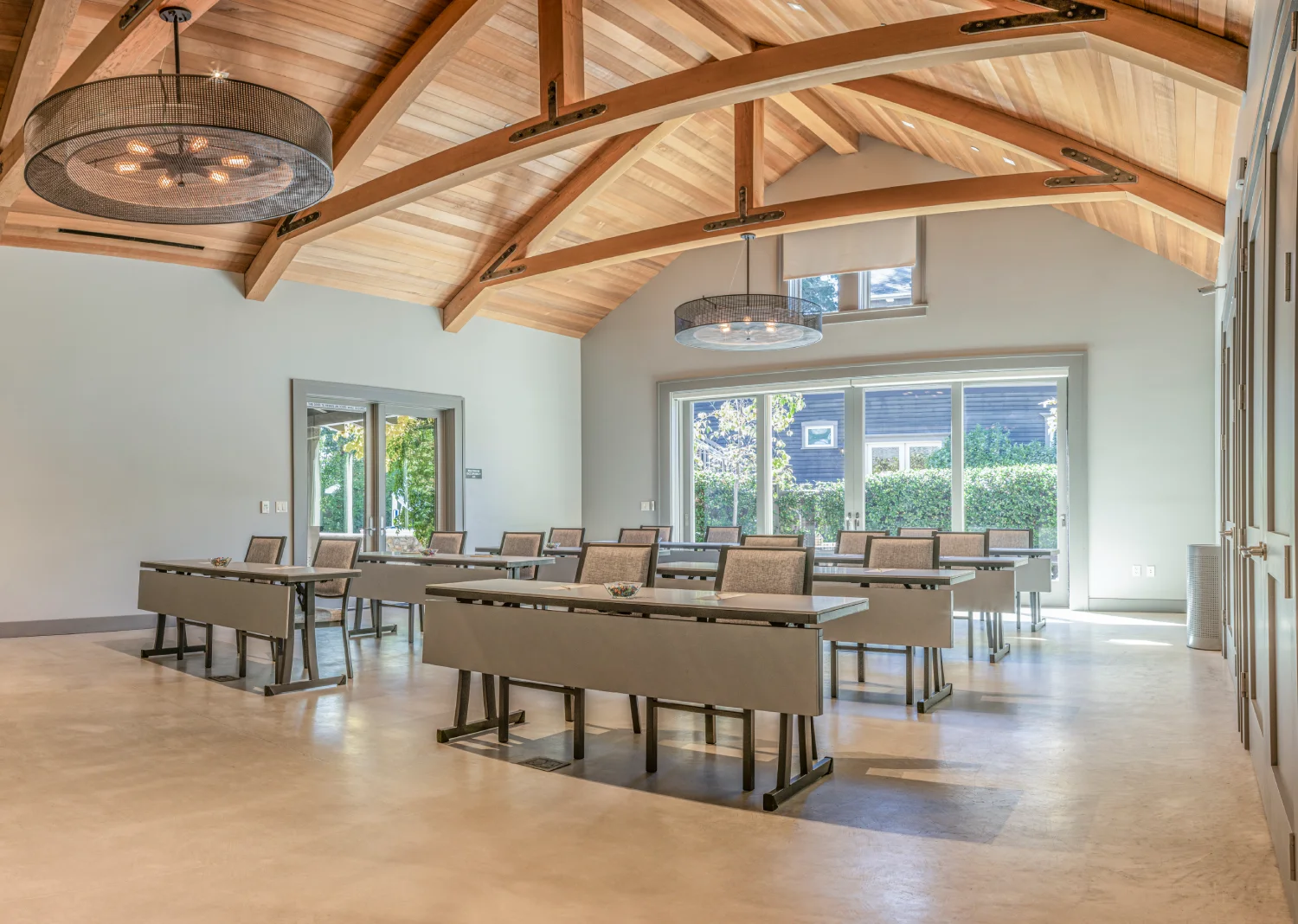 Spacious event room with vaulted wooden ceilings and classroom seating