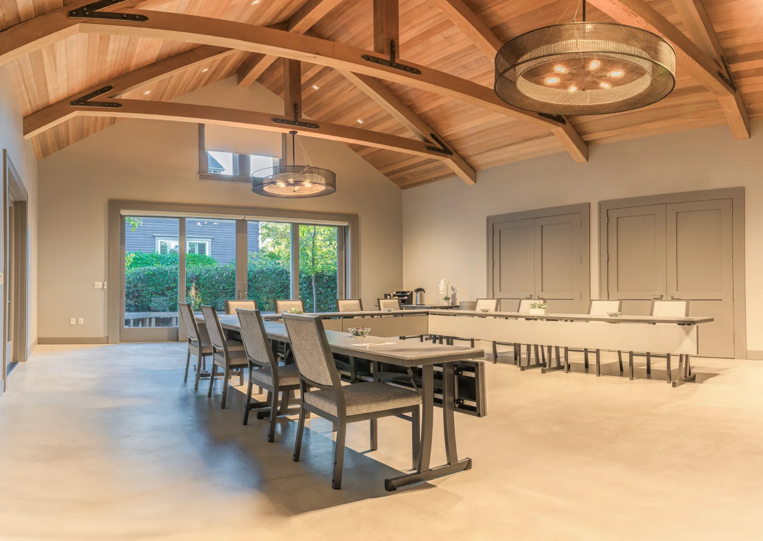 Spacious meeting room with vaulted wooden ceilings and U-shaped table setup