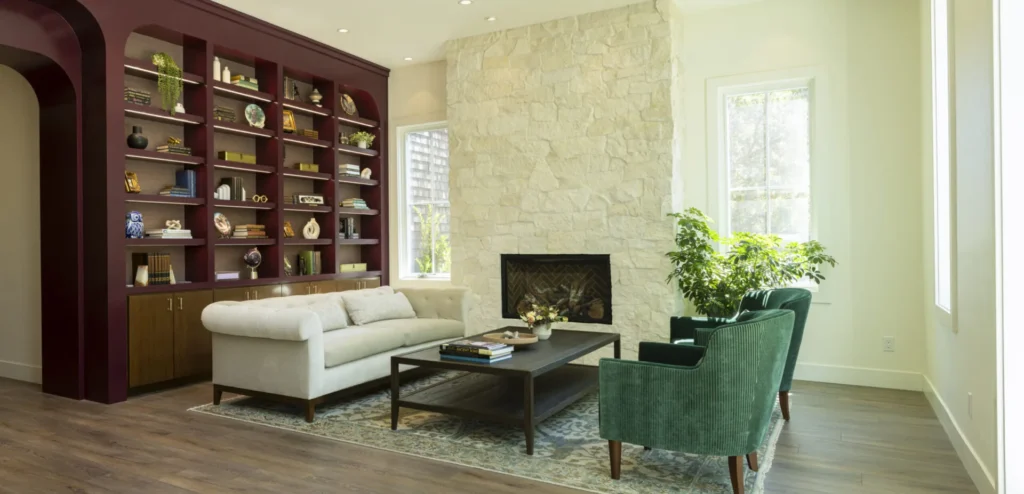 Elegant hotel lounge with stone fireplace and built-in bookshelves