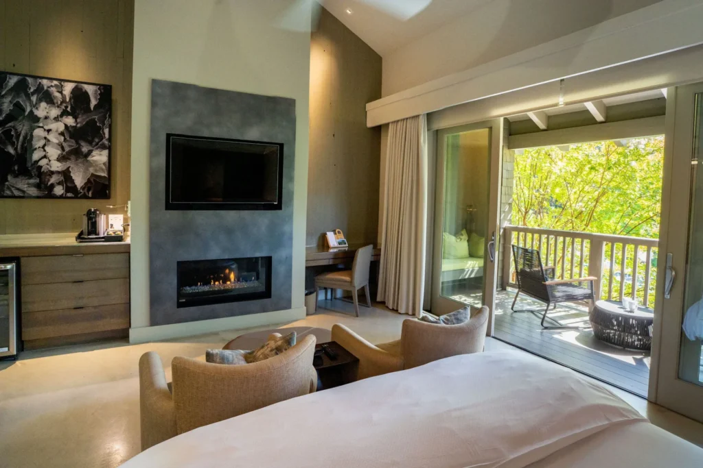 Luxury hotel room with fireplace, balcony, and modern furnishings