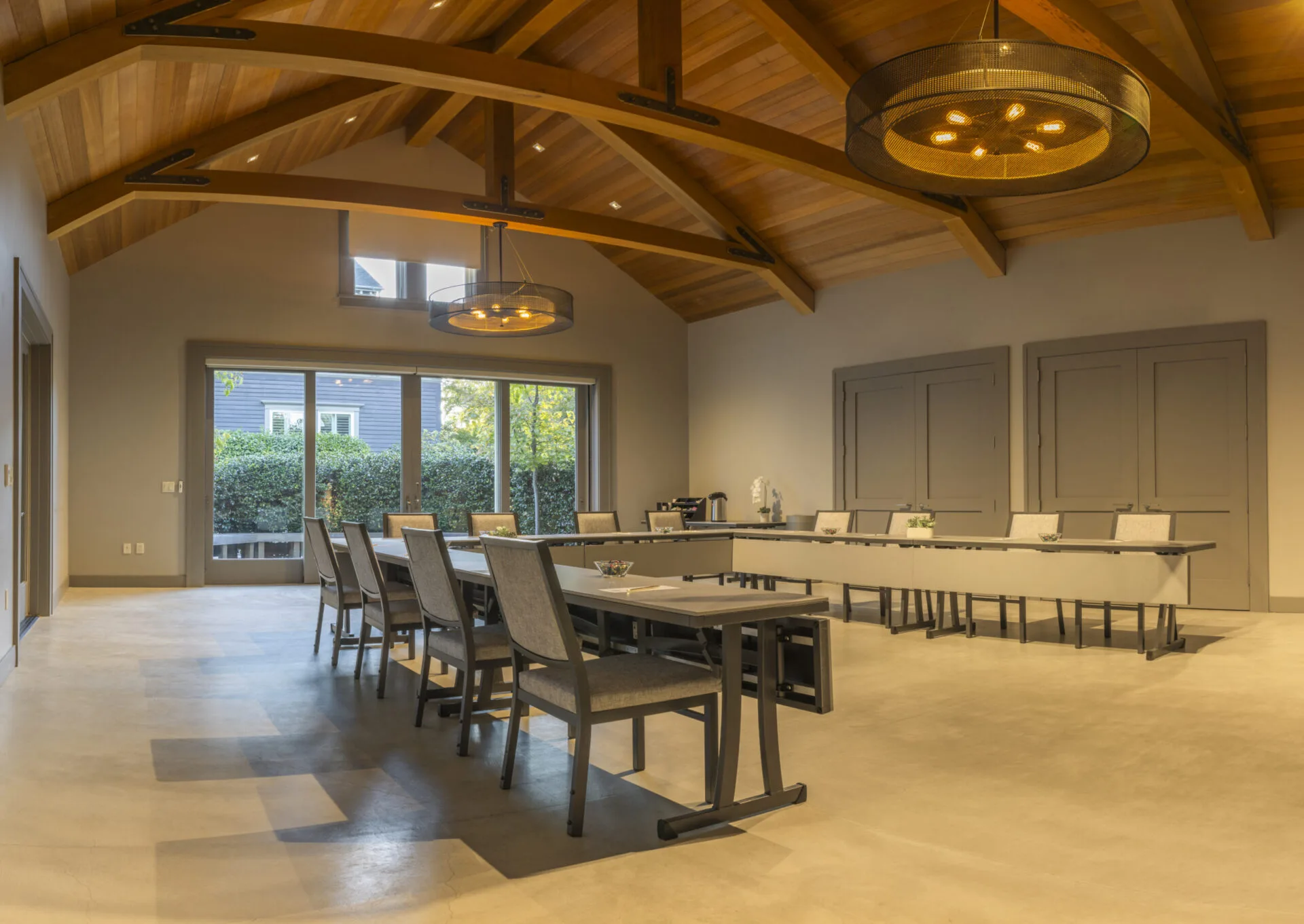 Modern meeting room with wooden beam ceiling and U-shaped table setup